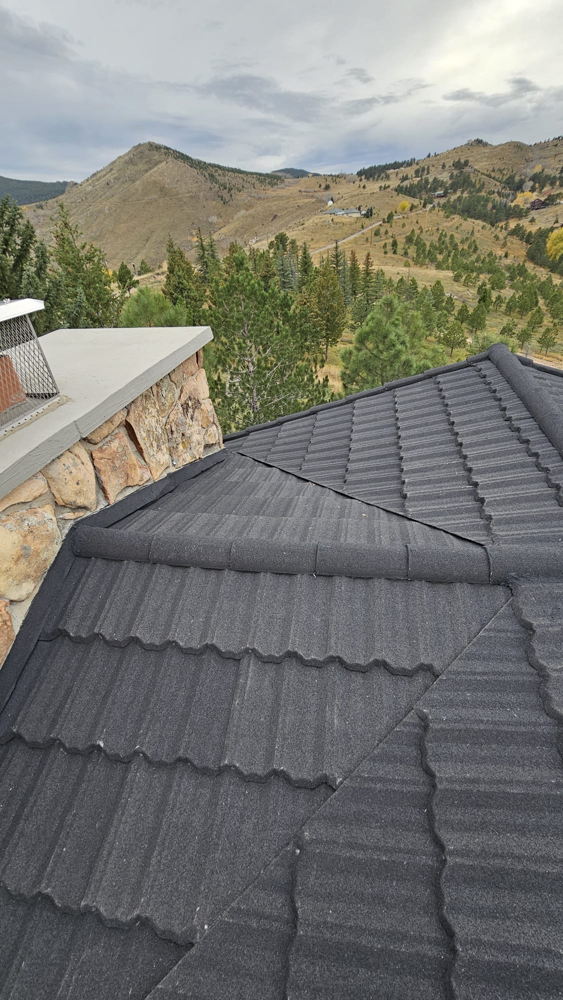 Stone-coated steel ridge on a Colorado mountain home, Class 4 impact rated roof